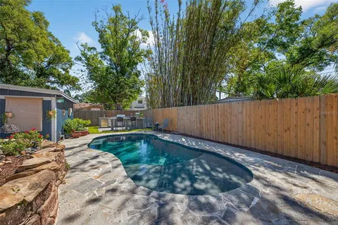 a view of a patio with table and chairs potted plants with wooden fence