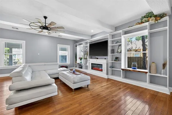 a living room with fireplace furniture and a flat screen tv