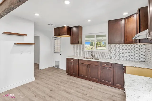 a spacious bathroom with a sink a mirror and a shower