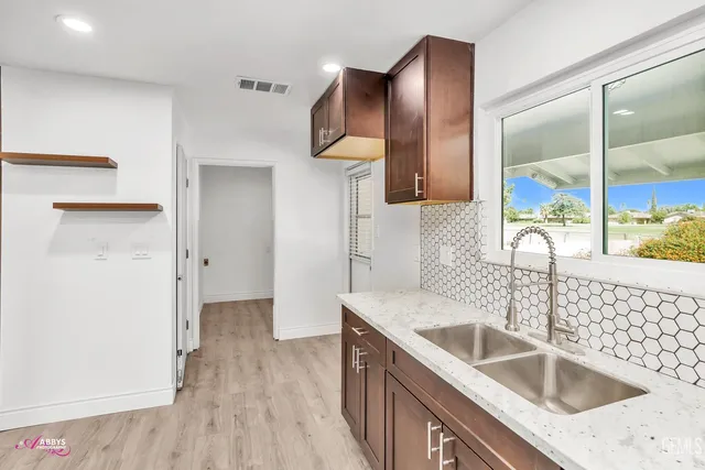 a kitchen with a sink and a refrigerator