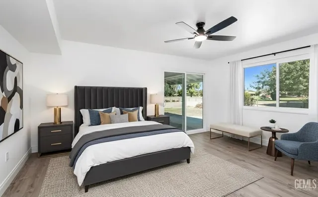 a spacious bedroom with a bed and glass window