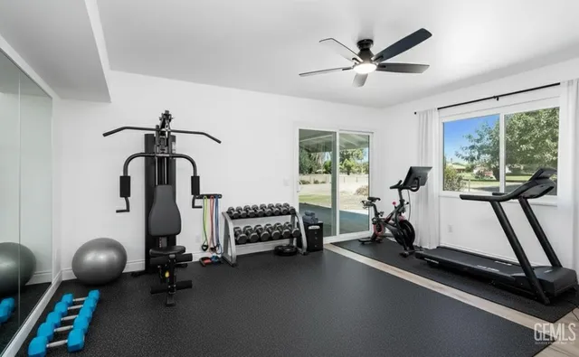 a room with gym equipment and a large window
