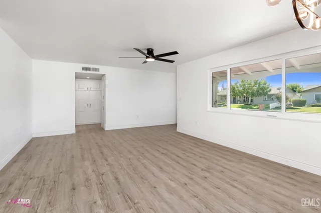 wooden floor in an empty room with a window