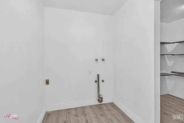 a view of a room with wooden floor
