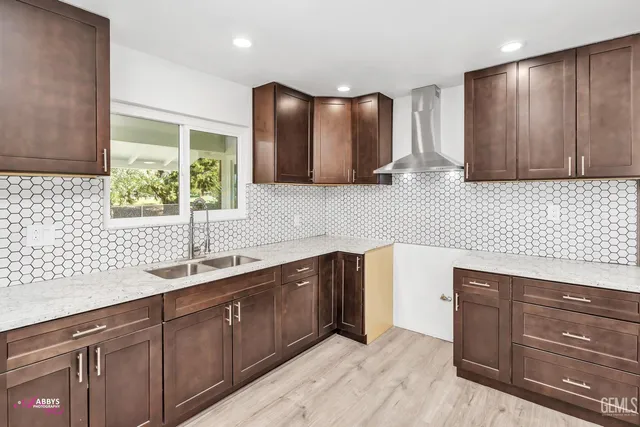 a kitchen with stainless steel appliances granite countertop wooden cabinets a sink and dishwasher