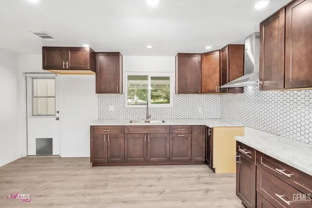 a kitchen with stainless steel appliances granite countertop a sink refrigerator and microwave