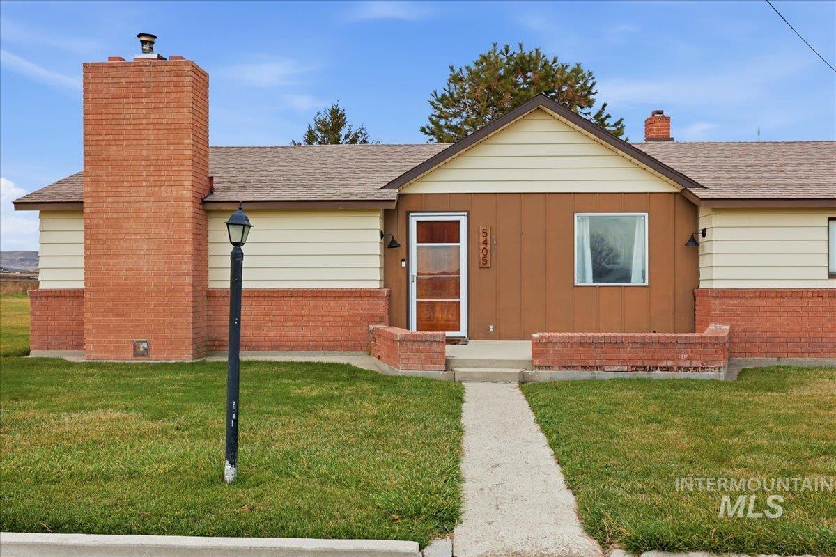 5405 Hogg Road Homedale, ID 83628 - Photo 2 of 29 View of front of house with a chimney, roof with shingles, and a front yard