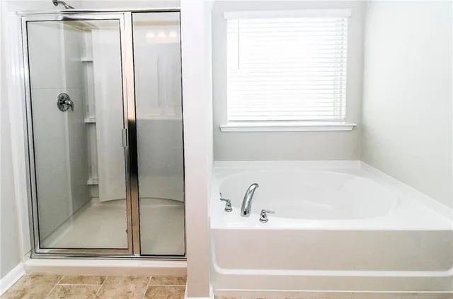 a bathroom with a bathtub and a shower