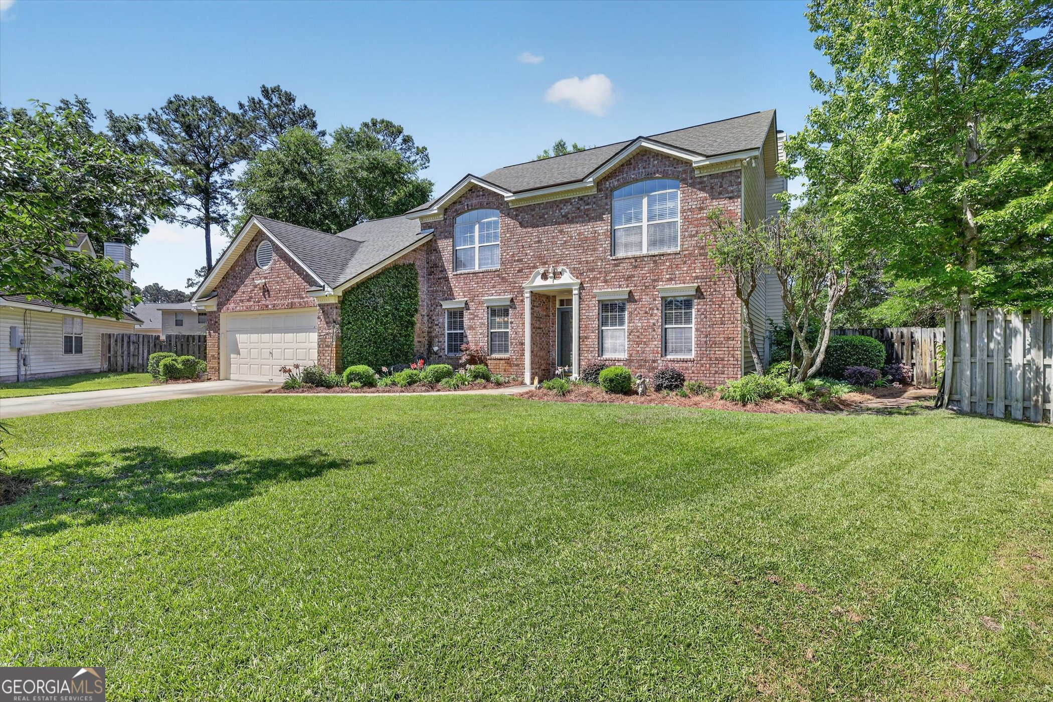 7 Towne Lake Court Pooler, GA 31322 - Photo 2 of 50 a front view of a house with a yard and trees