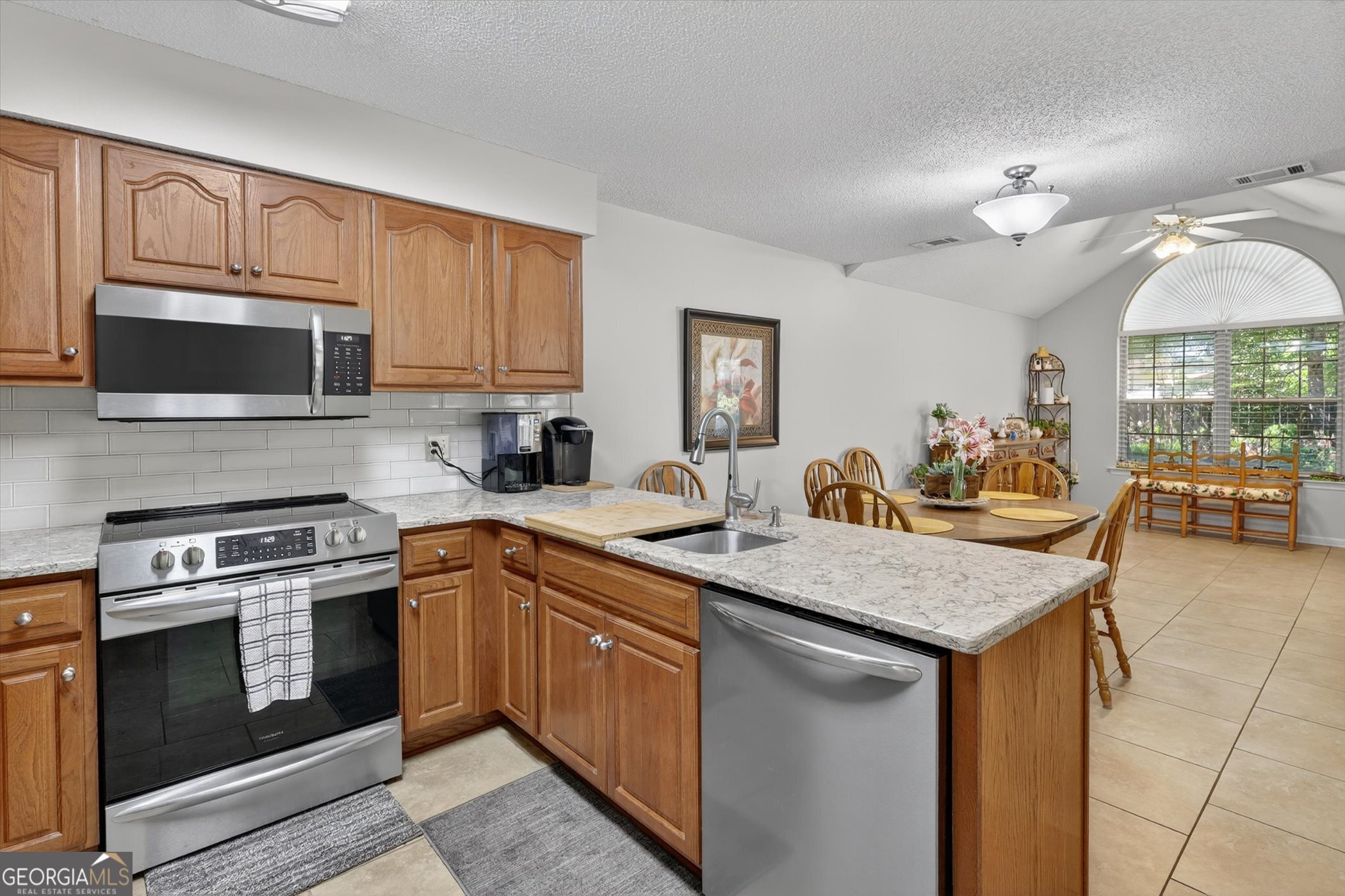 7 Towne Lake Court Pooler, GA 31322 - Photo 21 of 50 a kitchen with stainless steel appliances granite countertop a stove sink microwave and refrigerator
