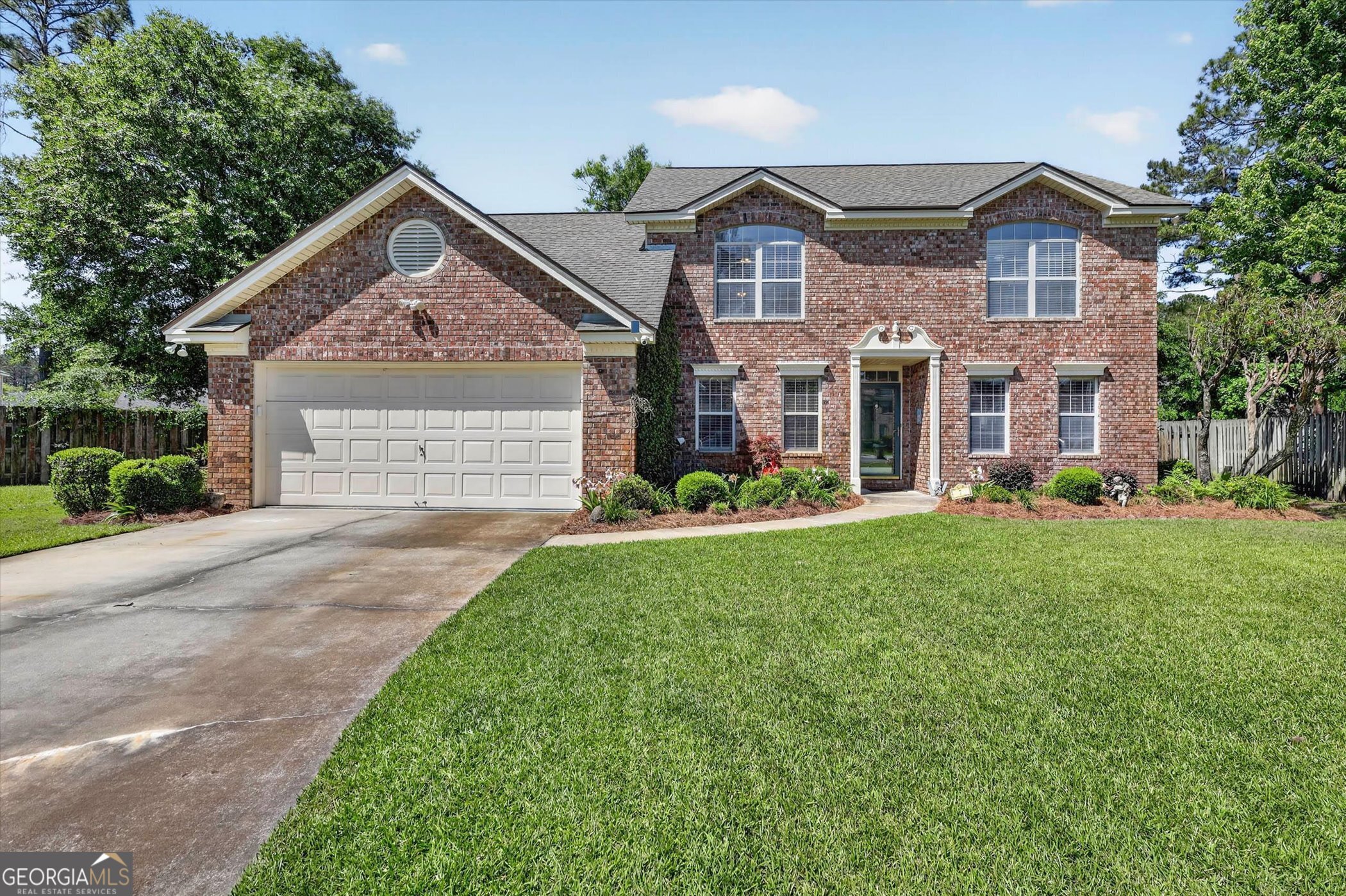 7 Towne Lake Court Pooler, GA 31322 - Photo 3 of 50 a front view of a house with a yard and garage