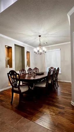 a view of a dining room with furniture and wooden floor