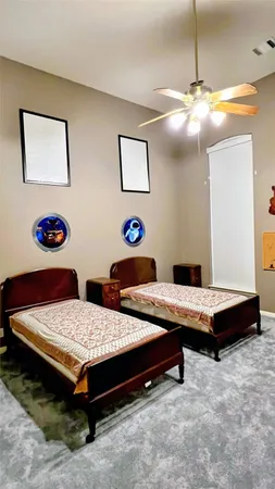 a living room with pool table and wall paintings