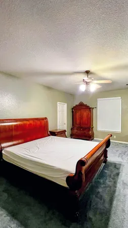 a bedroom with a bed and window