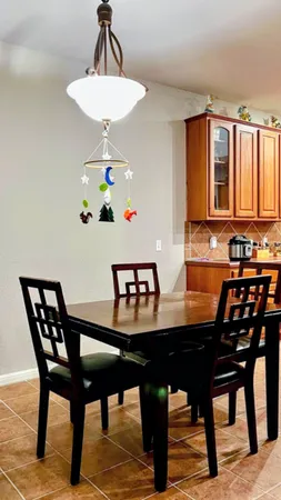 a view of a dining room with a table and chairs