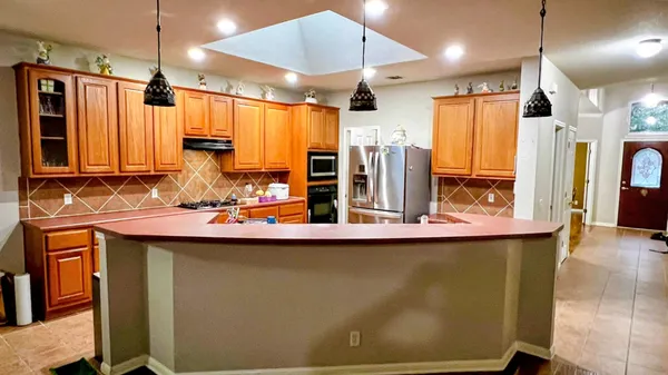 a kitchen with stainless steel appliances a sink stove and refrigerator