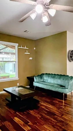 a wooden floor with a table and chairs