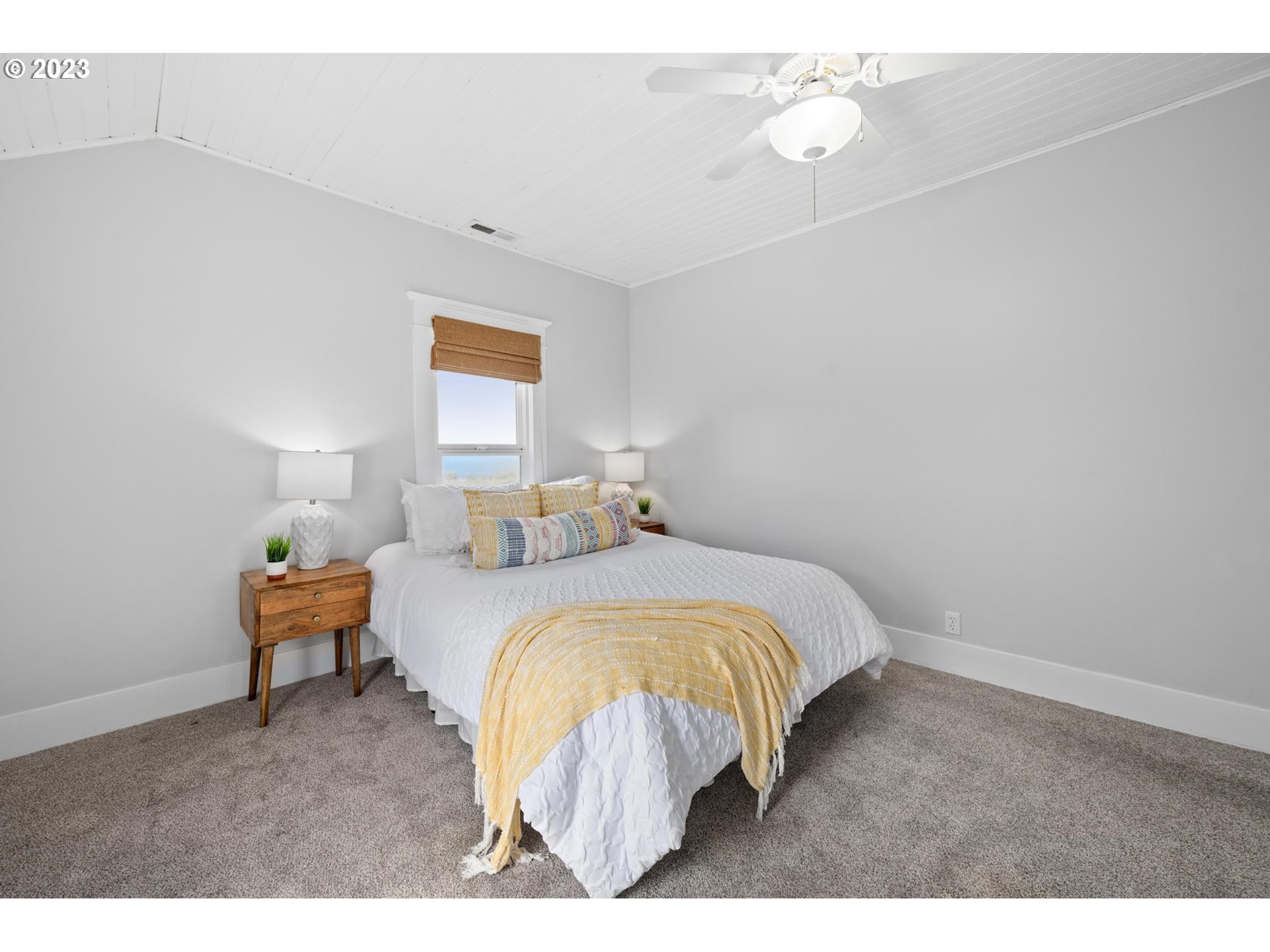 531 35th Street Astoria, OR 97103 - Photo 19 of 37 a bed room with a bed and a painting