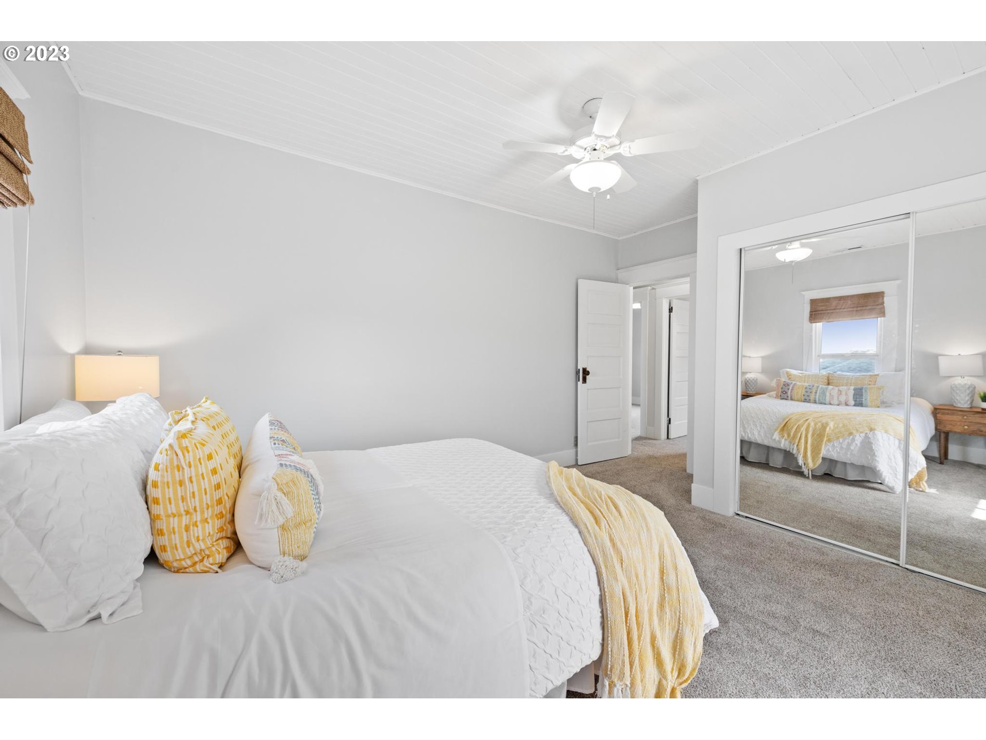 531 35th Street Astoria, OR 97103 - Photo 20 of 37 a bedroom with a bed and a chandelier