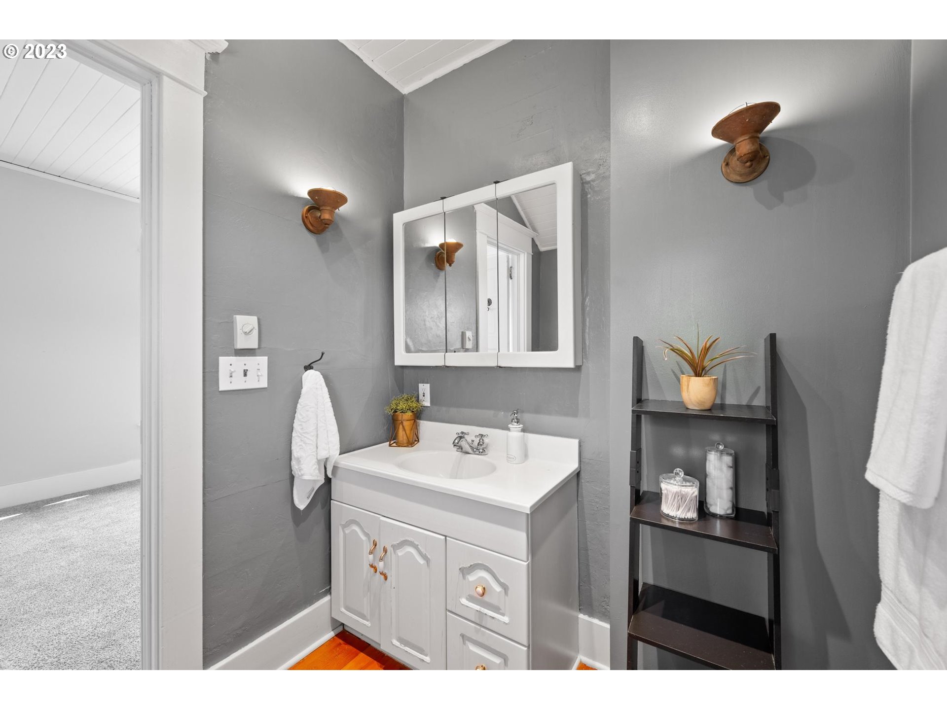 531 35th Street Astoria, OR 97103 - Photo 26 of 37 a bathroom with a sink a mirror and vanity