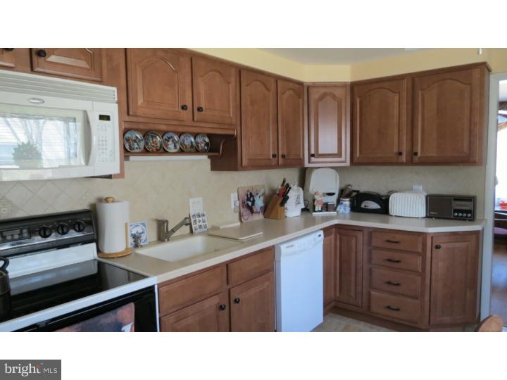 950 Chesterfield Road Barrington, NJ 08033 - Photo 7 of 14 a kitchen with a sink window and cabinets
