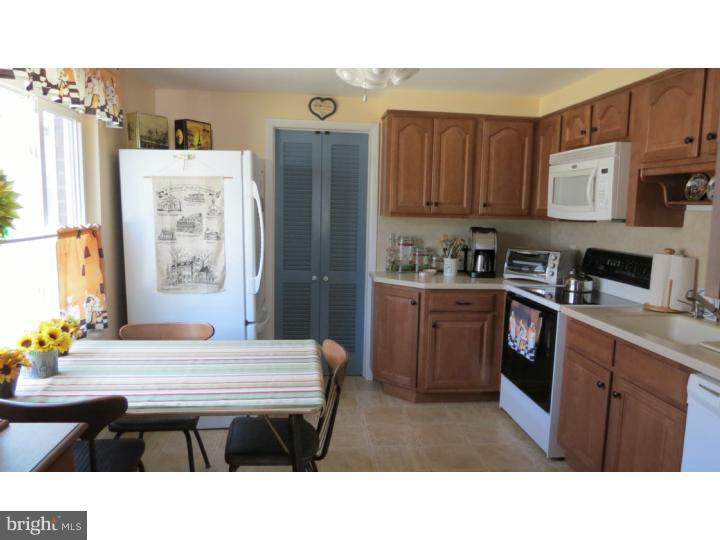 950 Chesterfield Road Barrington, NJ 08033 - Photo 8 of 14 a kitchen with stainless steel appliances kitchen island granite countertop a table chairs and a refrigerator