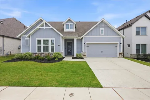 a view of a brick house with a yard