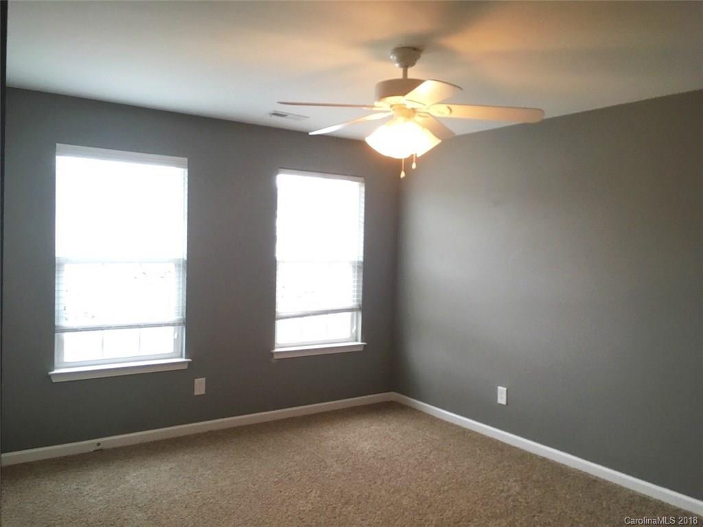 751 Prospect Lane, Unit 37 Fort Mill, SC 29708 - Photo 11 of 12 an empty room with windows and chandelier fan