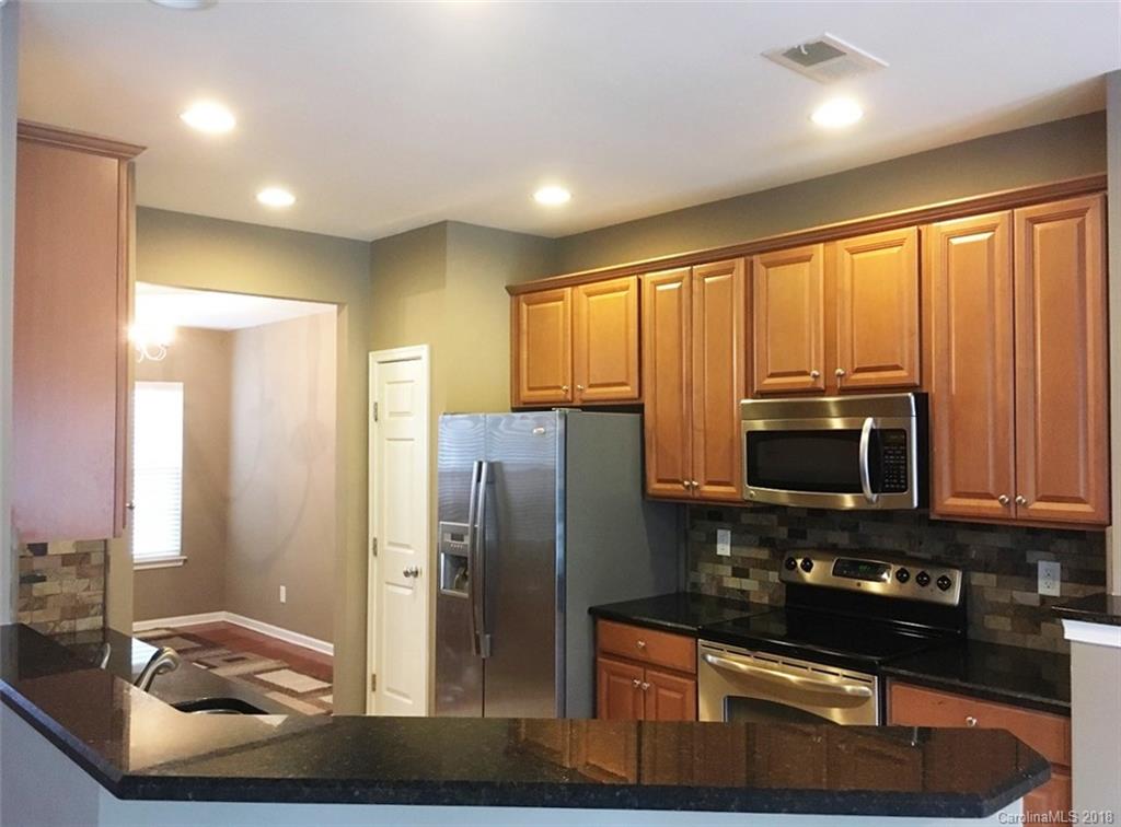 751 Prospect Lane, Unit 37 Fort Mill, SC 29708 - Photo 5 of 12 a kitchen with stainless steel appliances granite countertop a refrigerator and a stove
