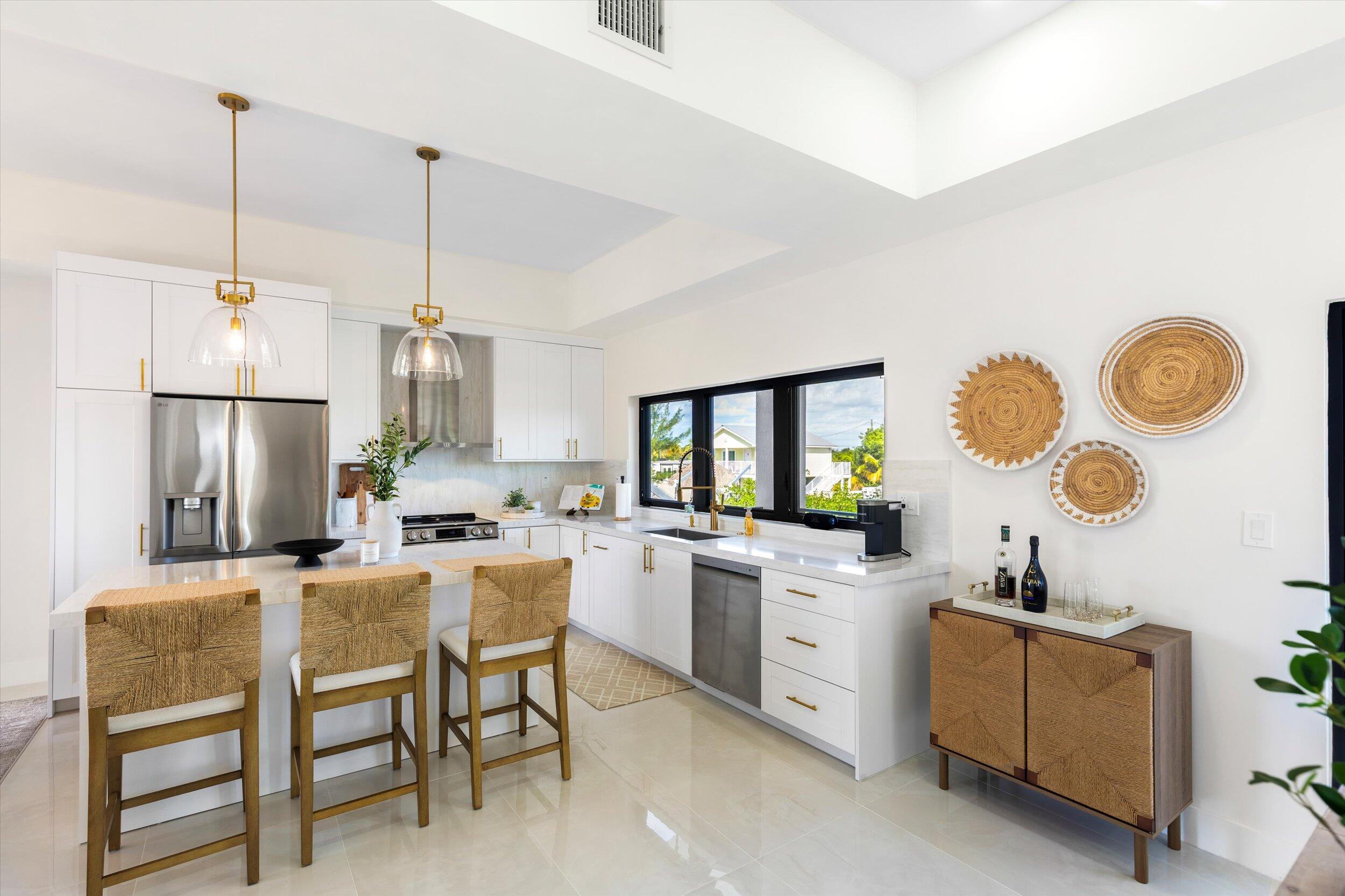 27433 Antigua Road Summerland Key, FL 33042 - Photo 19 of 64 a kitchen with sink cabinets and stainless steel appliances