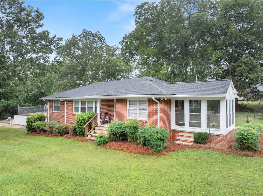 5907 Main Street Lula, GA 30554 - Photo 43 of 60 front view of a house with a yard