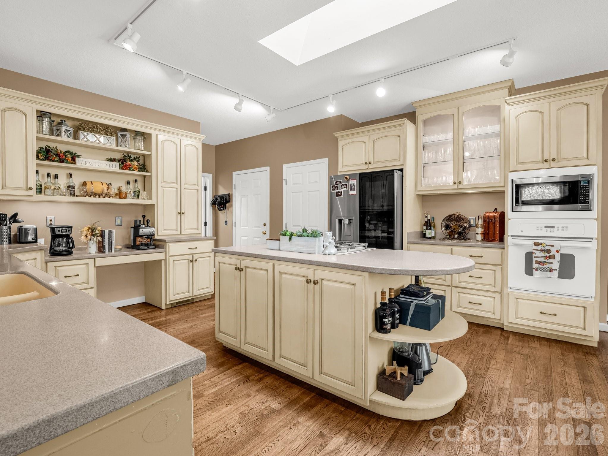 1424 Wolf Pen Road Old Fort, NC 28762 - Photo 12 of 45 a kitchen with white cabinets and appliances