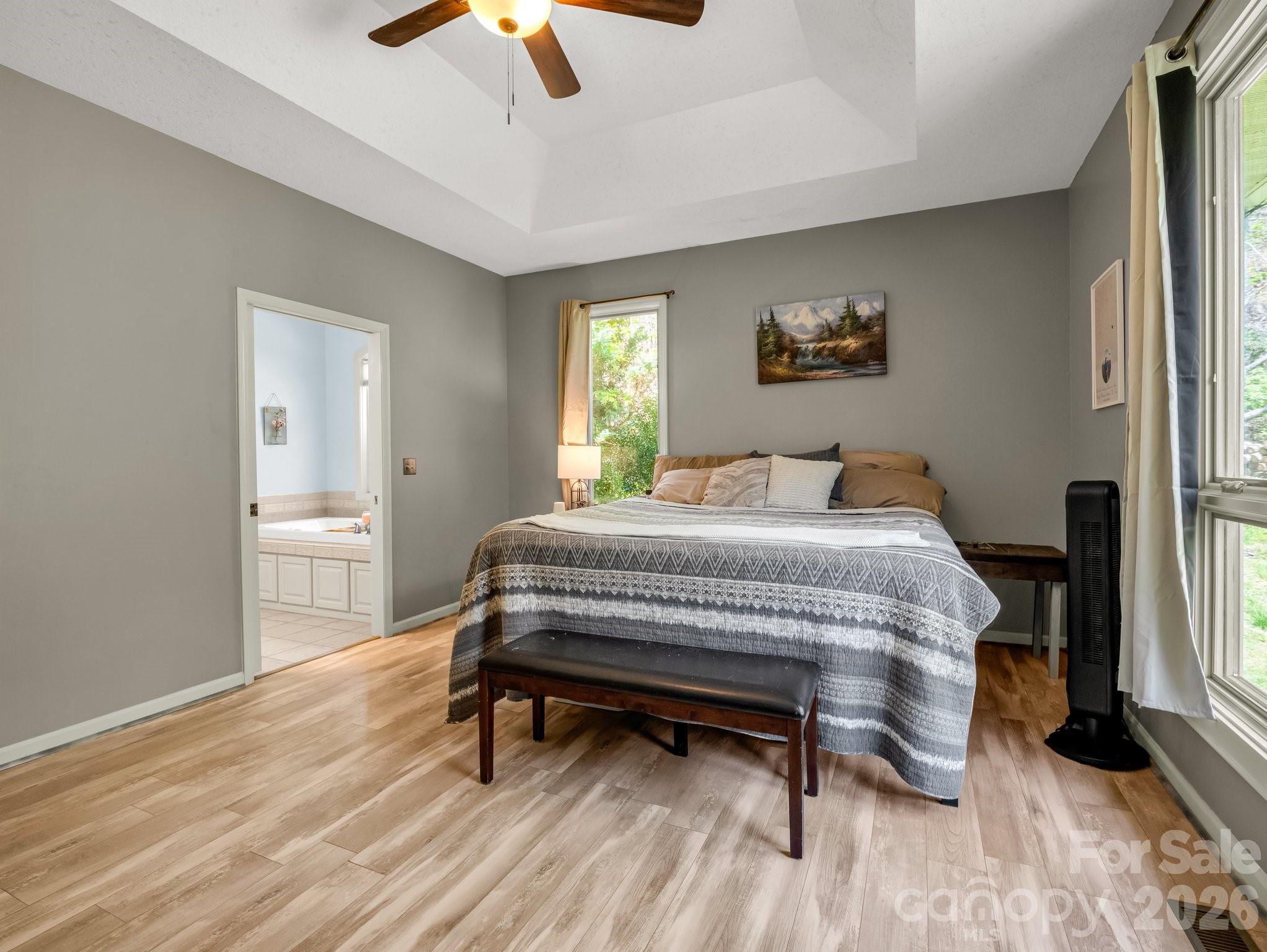 1424 Wolf Pen Road Old Fort, NC 28762 - Photo 15 of 45 a bedroom with a bed and a chandelier