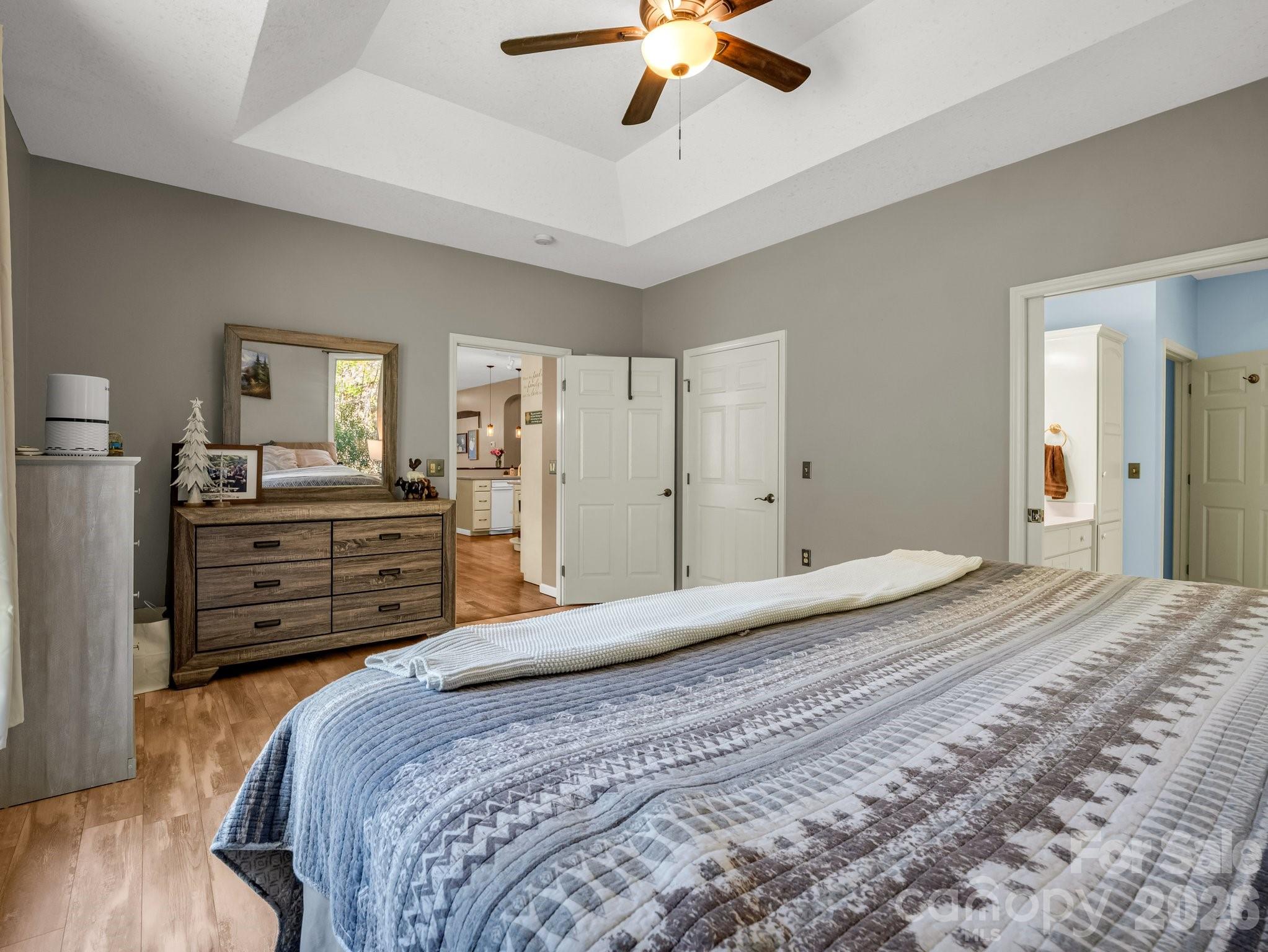 1424 Wolf Pen Road Old Fort, NC 28762 - Photo 16 of 45 a bedroom with a bed and a chandelier