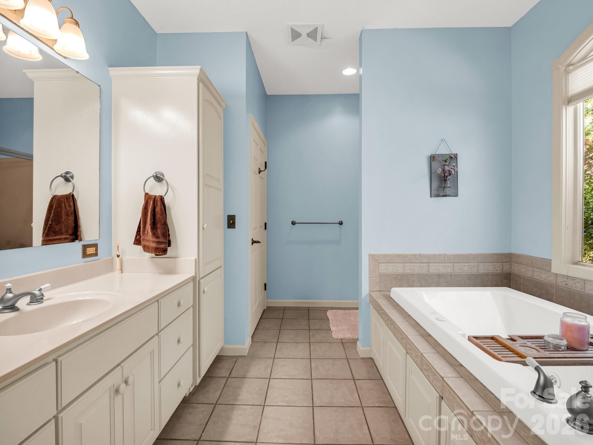 1424 Wolf Pen Road Old Fort, NC 28762 - Photo 17 of 45 a bathroom with a tub sink and mirror