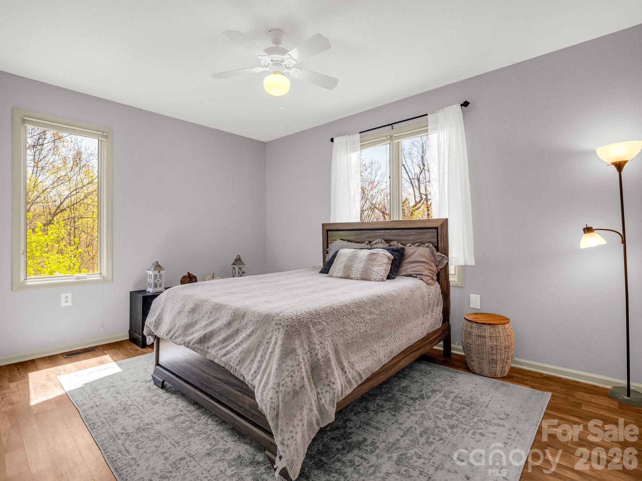 1424 Wolf Pen Road Old Fort, NC 28762 - Photo 22 of 45 a bedroom with a bed and wooden floor