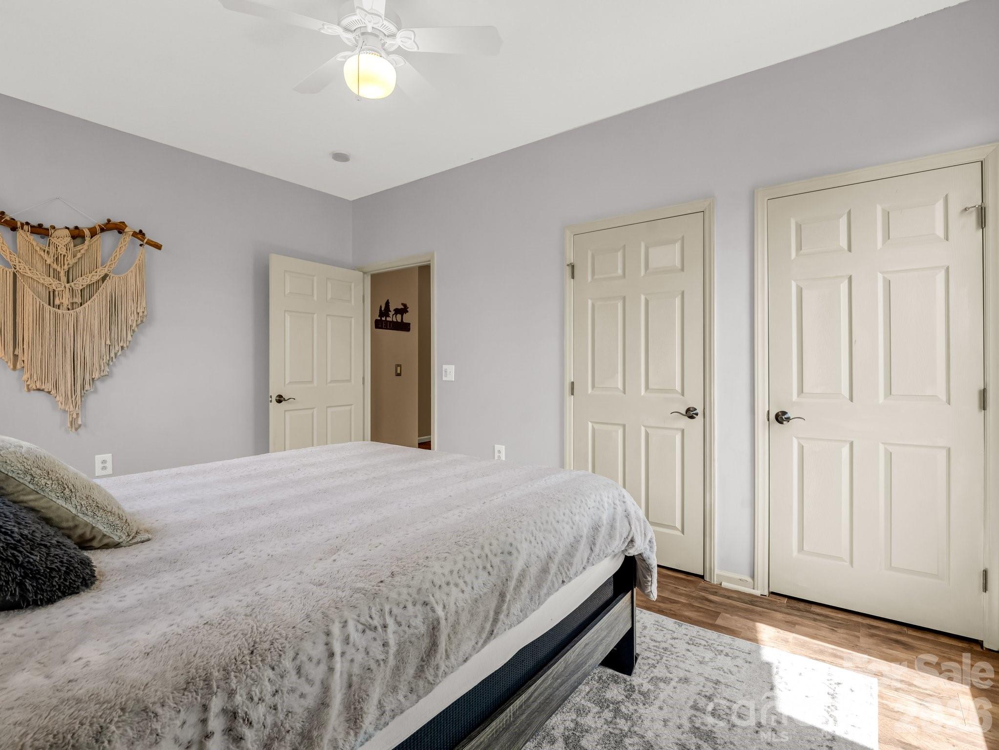 1424 Wolf Pen Road Old Fort, NC 28762 - Photo 23 of 45 a bedroom with a bed and a chandelier