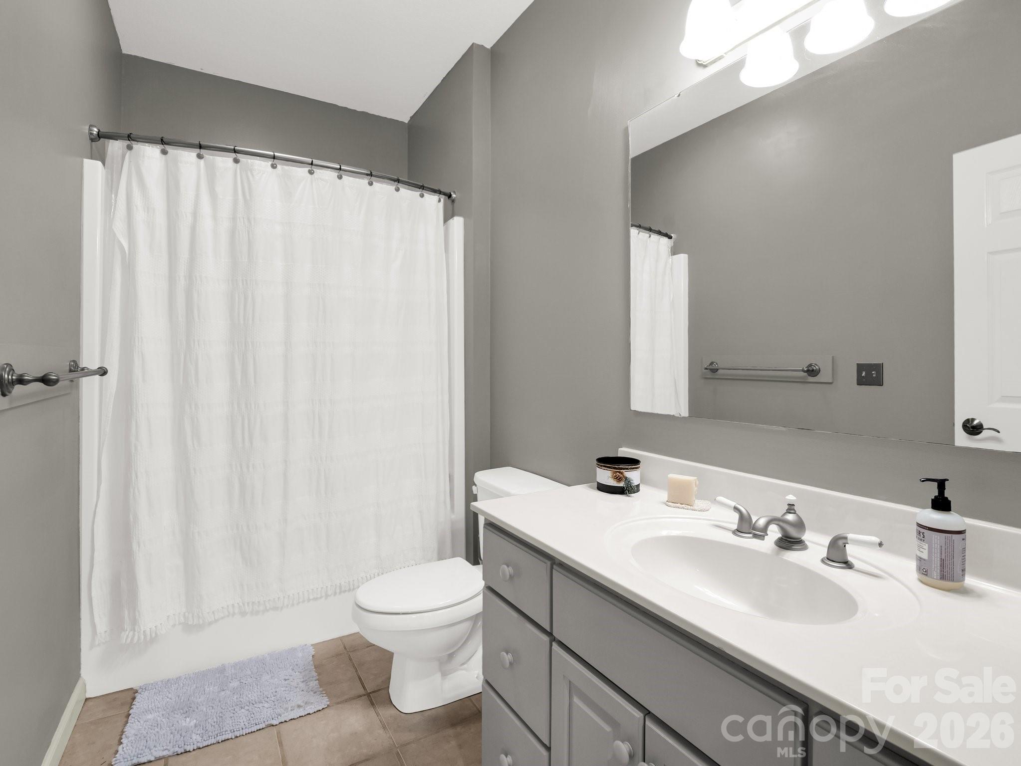 1424 Wolf Pen Road Old Fort, NC 28762 - Photo 26 of 45 a bathroom with a double vanity sink toilet and a mirror