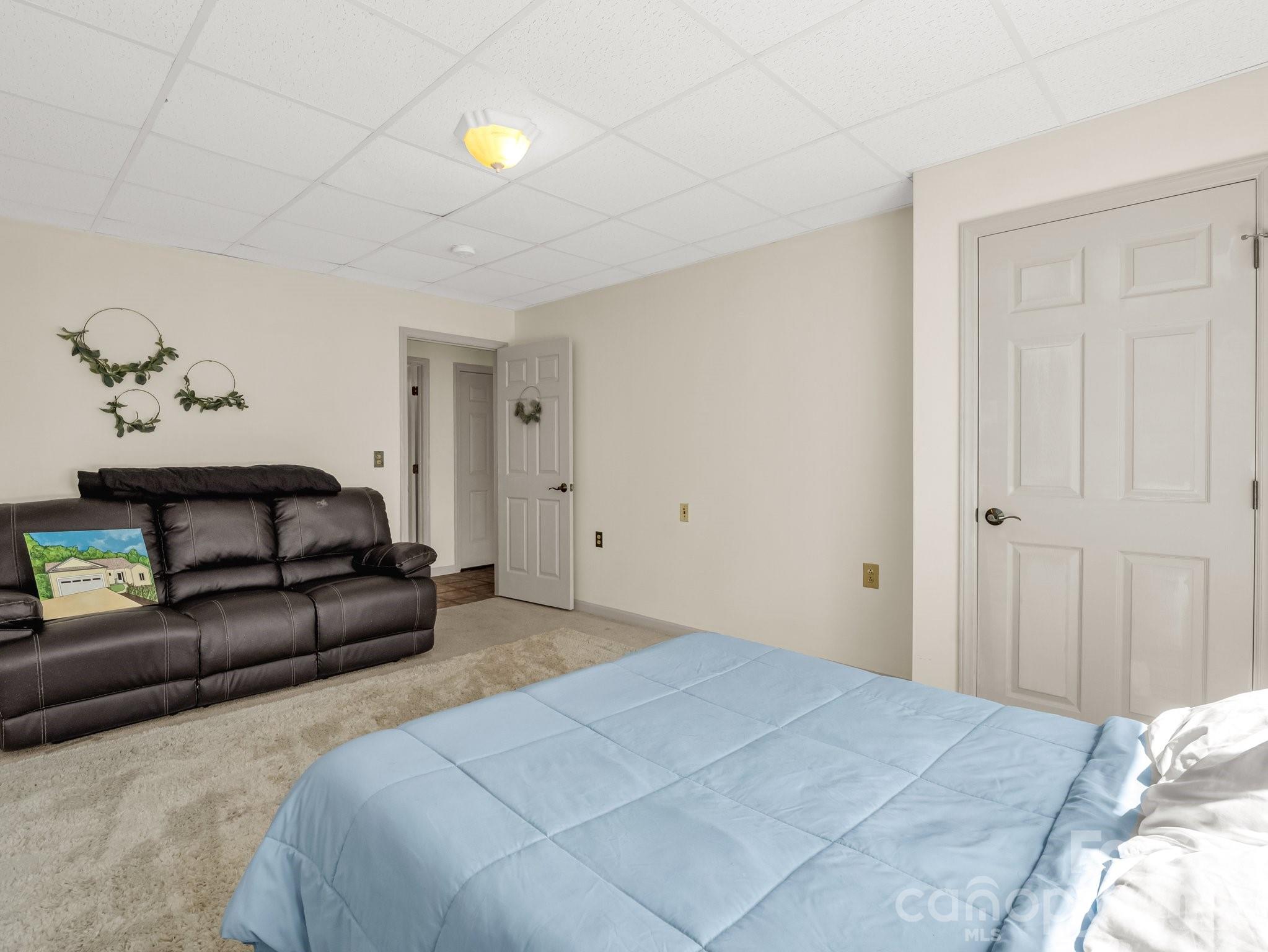 1424 Wolf Pen Road Old Fort, NC 28762 - Photo 33 of 45 a bedroom with a bed and a couch