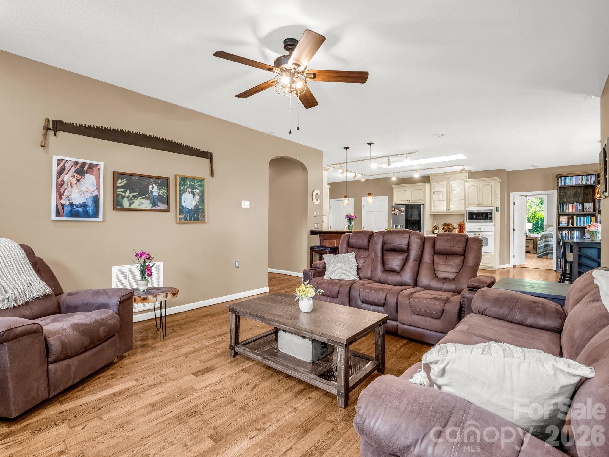 1424 Wolf Pen Road Old Fort, NC 28762 - Photo 5 of 45 a living room with furniture kitchen view and a wooden floor