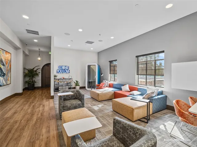 a living room with furniture wooden floor and window