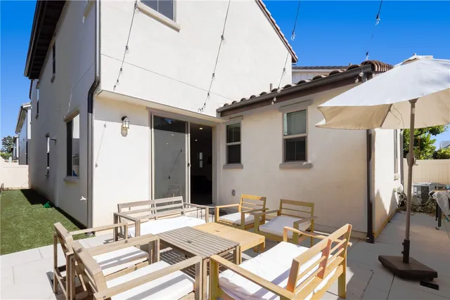 a view of a patio with table and chairs and potted plants