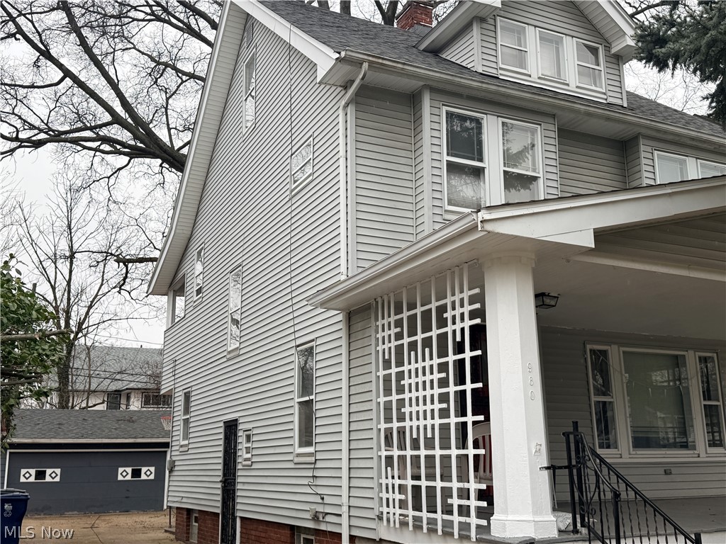 980 Brunswick Road Cleveland Heights, OH 44112 - Photo 2 of 11 View of side of home with roof with shingles, a chimney, and covered porch