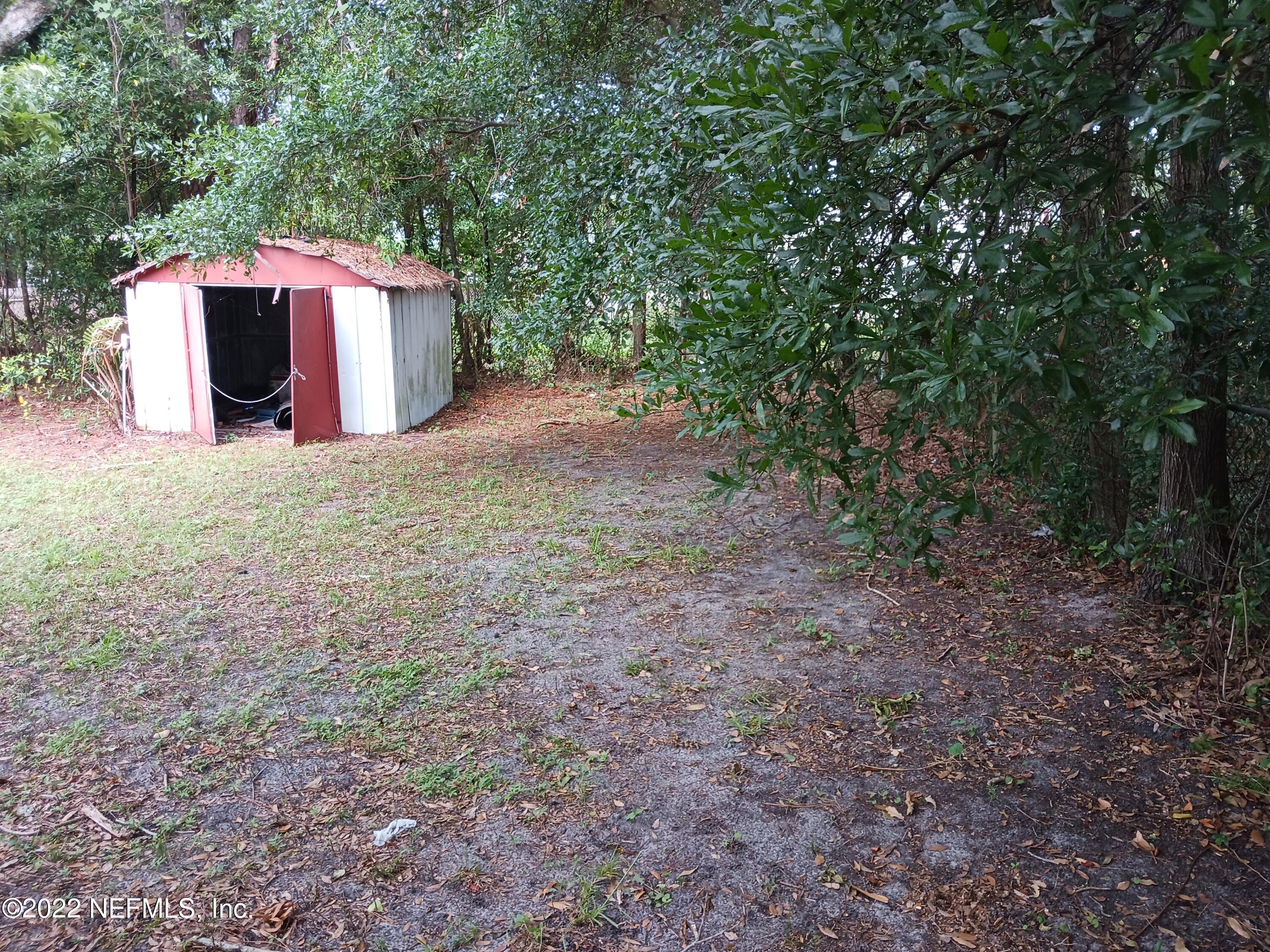 1914 Rogero Road Jacksonville, FL 32211 - Photo 13 of 18 a view of a backyard with a barn