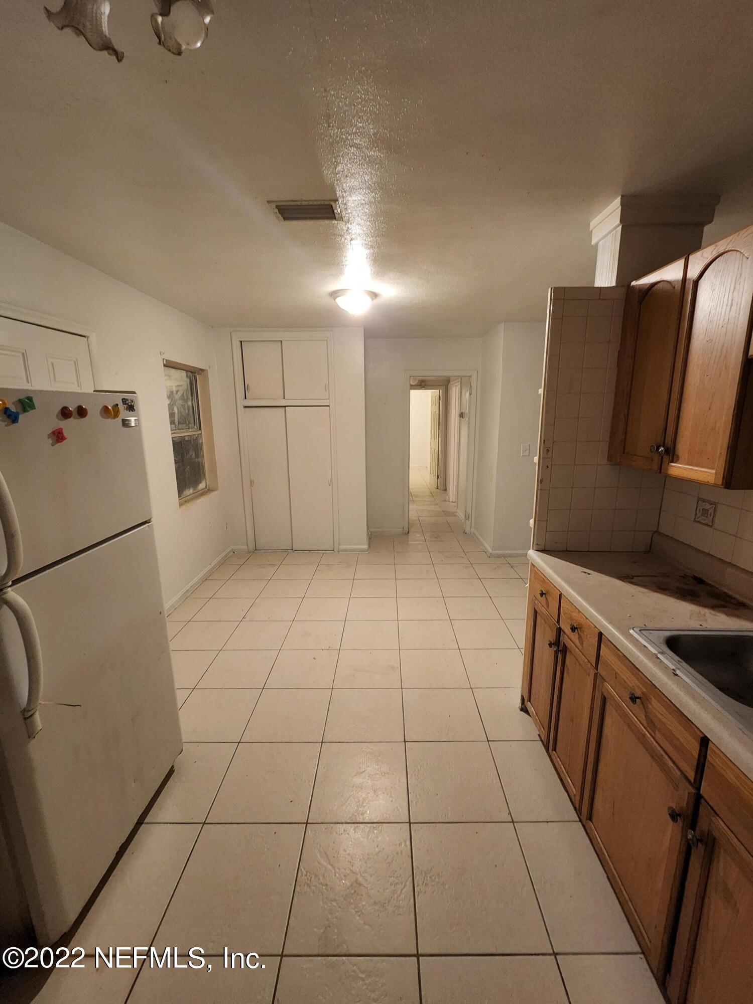 1914 Rogero Road Jacksonville, FL 32211 - Photo 5 of 18 a view of a kitchen with refrigerator and microwave