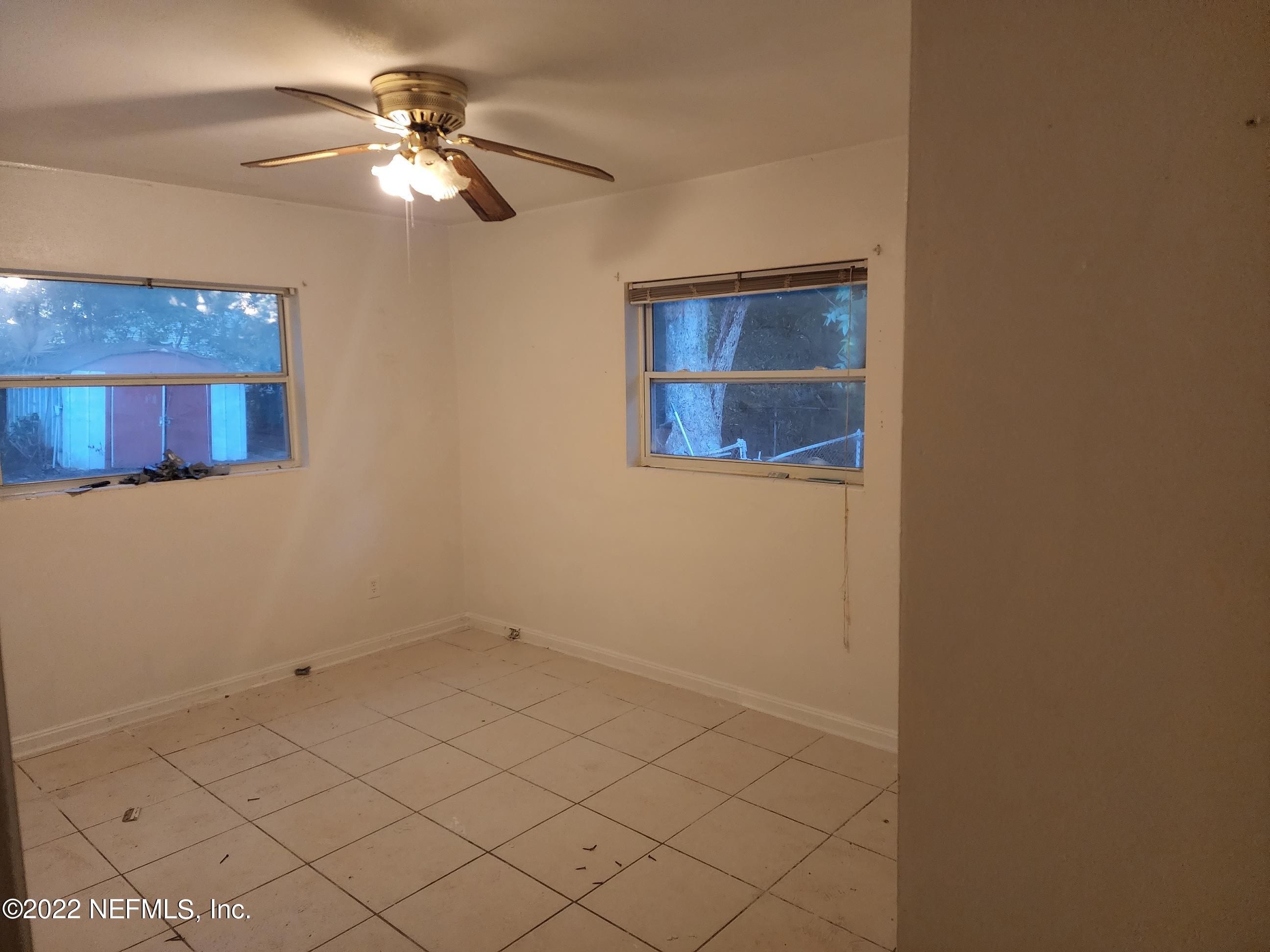 1914 Rogero Road Jacksonville, FL 32211 - Photo 7 of 18 a view of a livingroom with a ceiling fan and a window