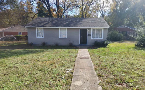 a front view of a house with a yard and pathway
