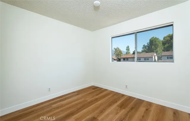 a view of living room with a balcony a bed and a potted plant