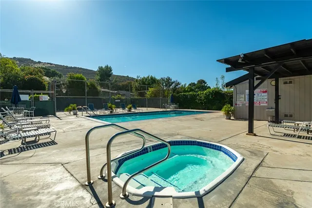 a view of a swimming pool with a patio and mountain view