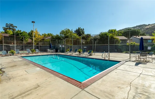 a view of swimming pool with chairs